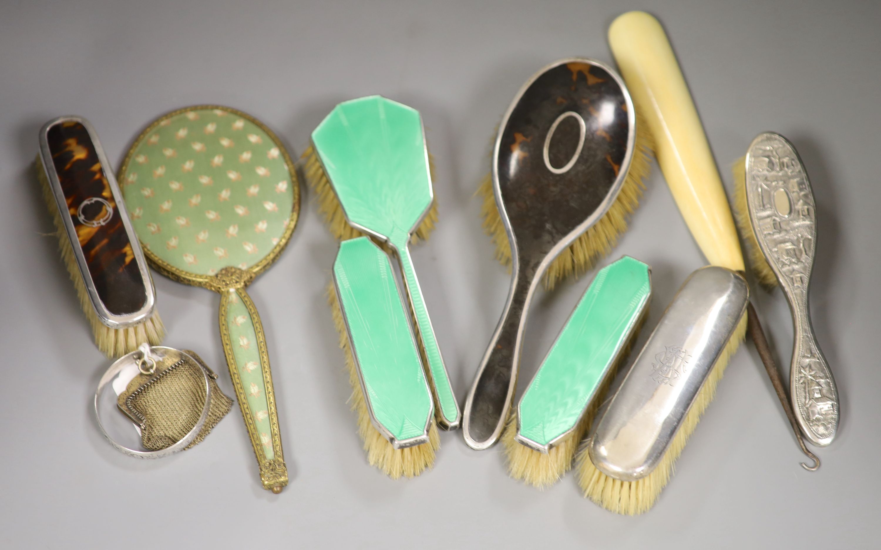 A guilloche enamel and silver-mounted three-piece brush and comb set, three other silver-mounted brushes and five other items,